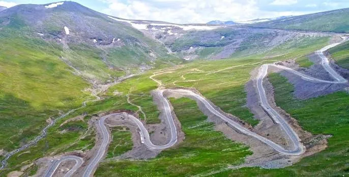 Winding road up the green slopes to Babusar Top